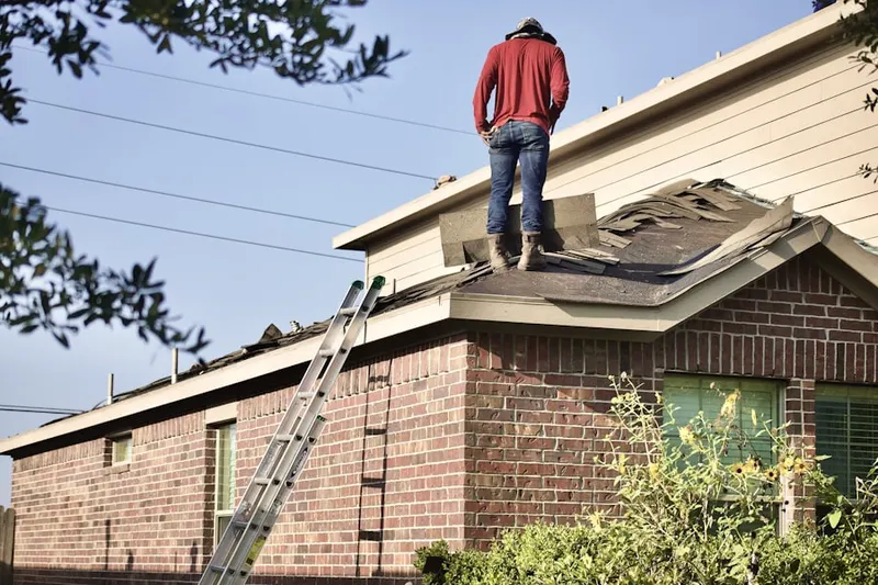 Professional roofer working on a residential roof in Stone Church